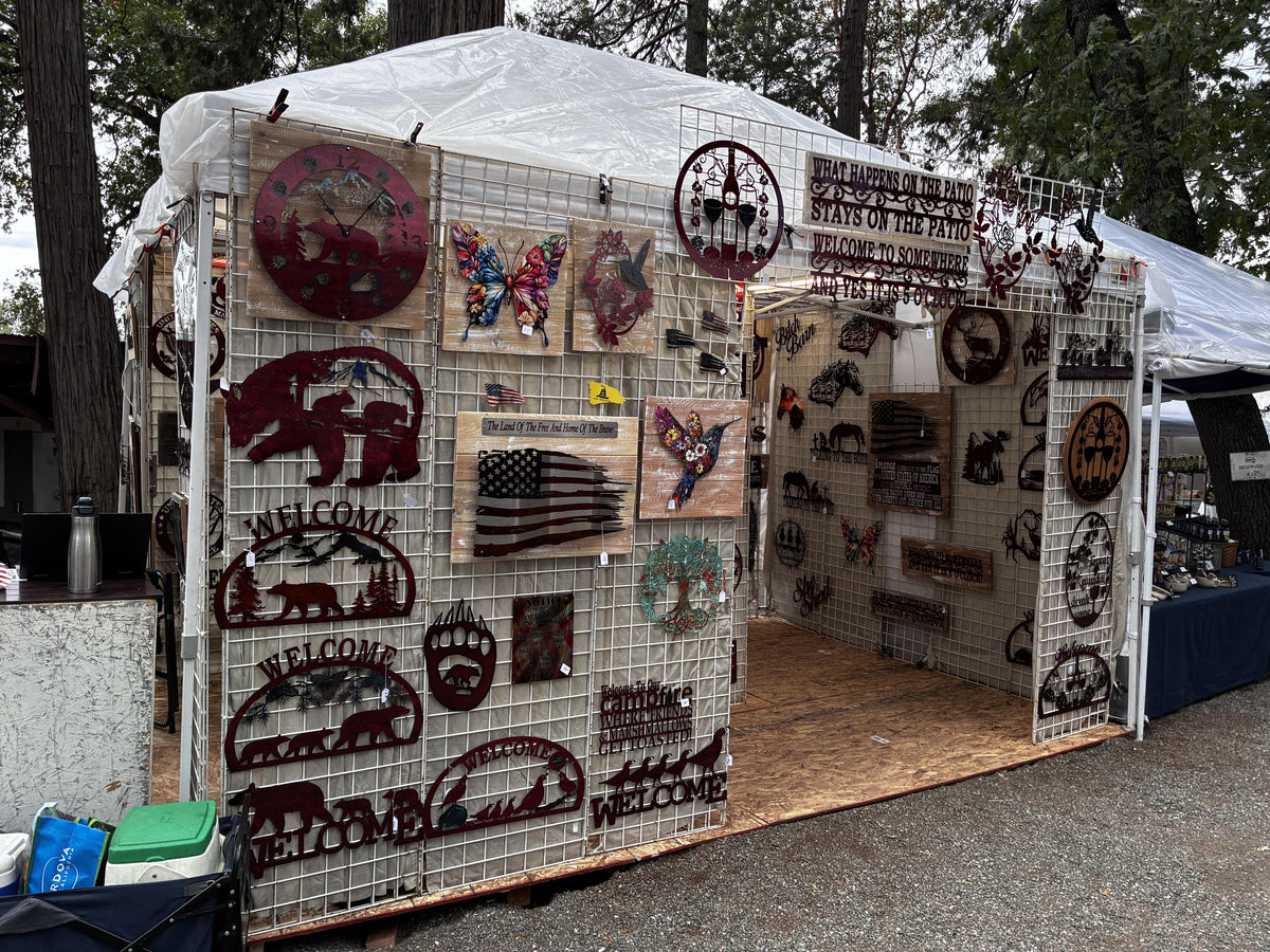 Hang Ups booth at Apple Hill — metal signs on grid-wall panels